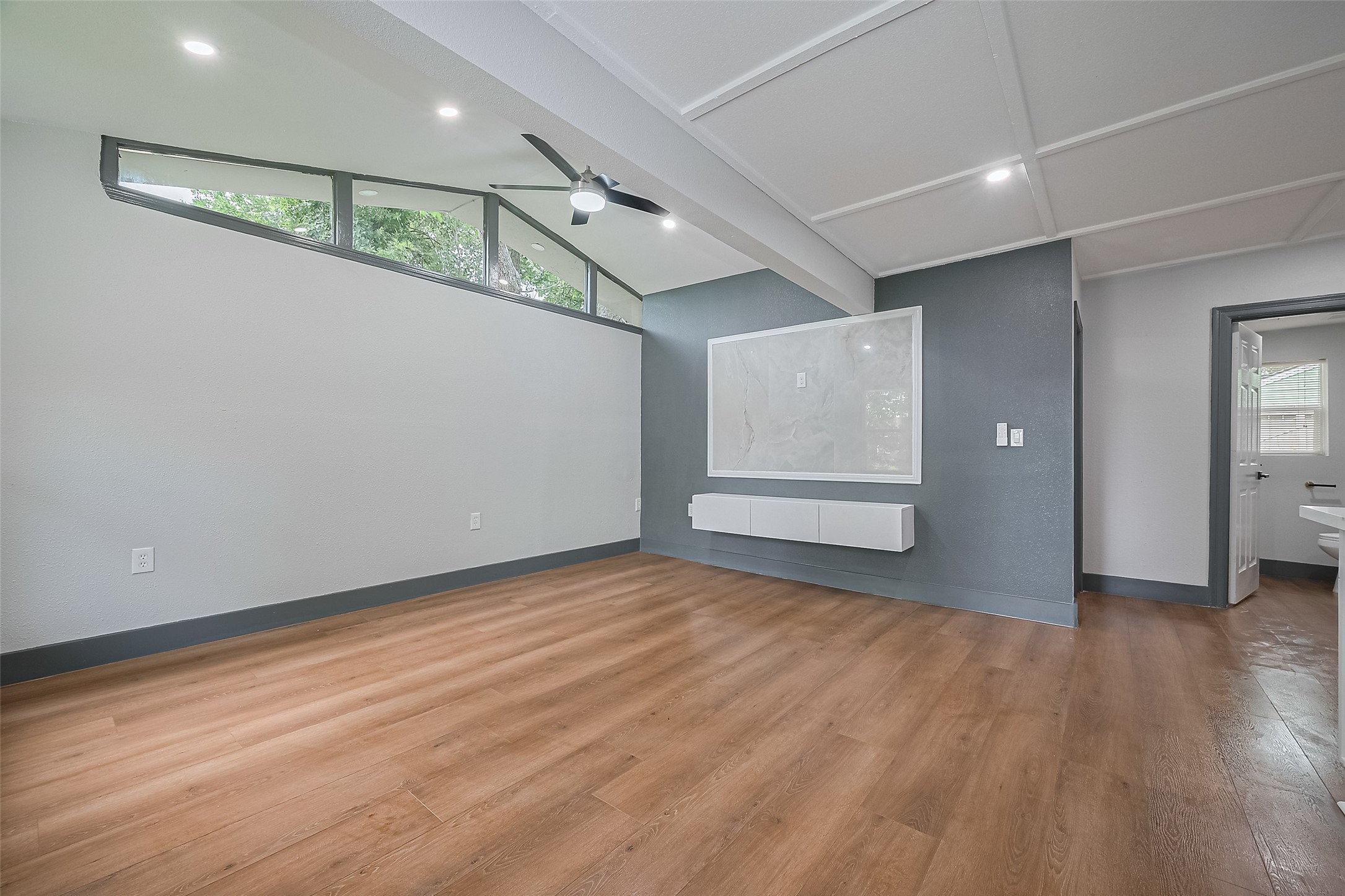 6058 Lyndhurst Drive Houston, TX 77033 - Photo 10 of 50 wooden floor in an empty room with a window