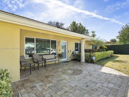 a view of a house with backyard porch and sitting area