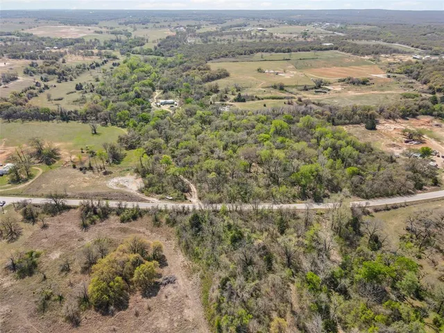 an aerial view of mountain with trees around