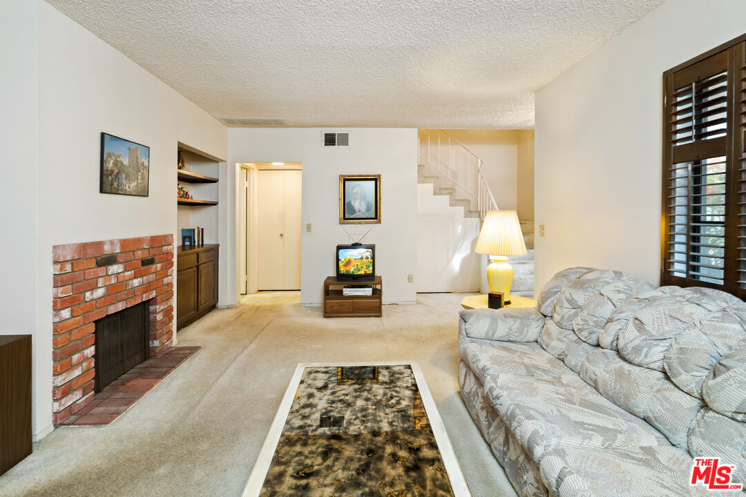 1445 Valley View Road, Unit 2 Glendale, CA 91202 - Photo 11 of 36 a bedroom with furniture and a fireplace