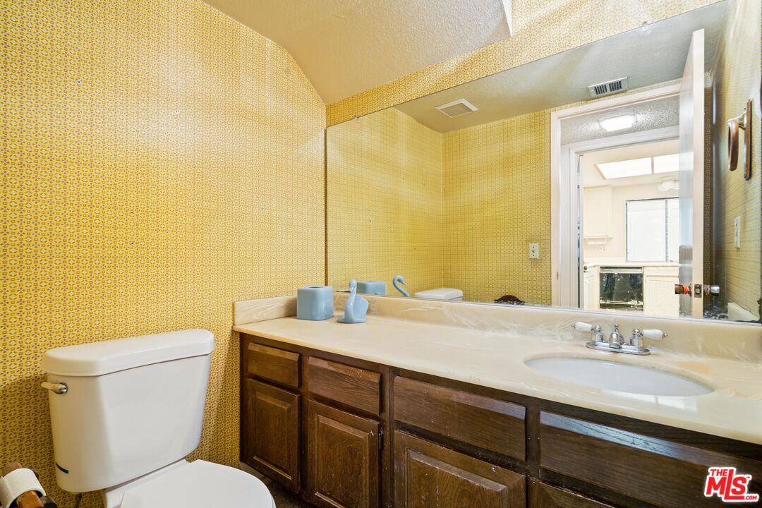 1445 Valley View Road, Unit 2 Glendale, CA 91202 - Photo 14 of 36 a bathroom with a granite countertop sink mirror and a toilet