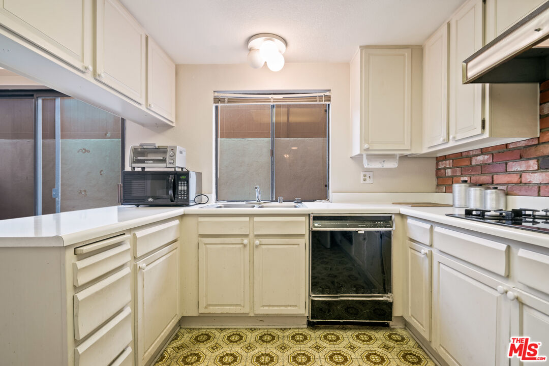 1445 Valley View Road, Unit 2 Glendale, CA 91202 - Photo 15 of 36 a kitchen with granite countertop a sink stove and cabinets