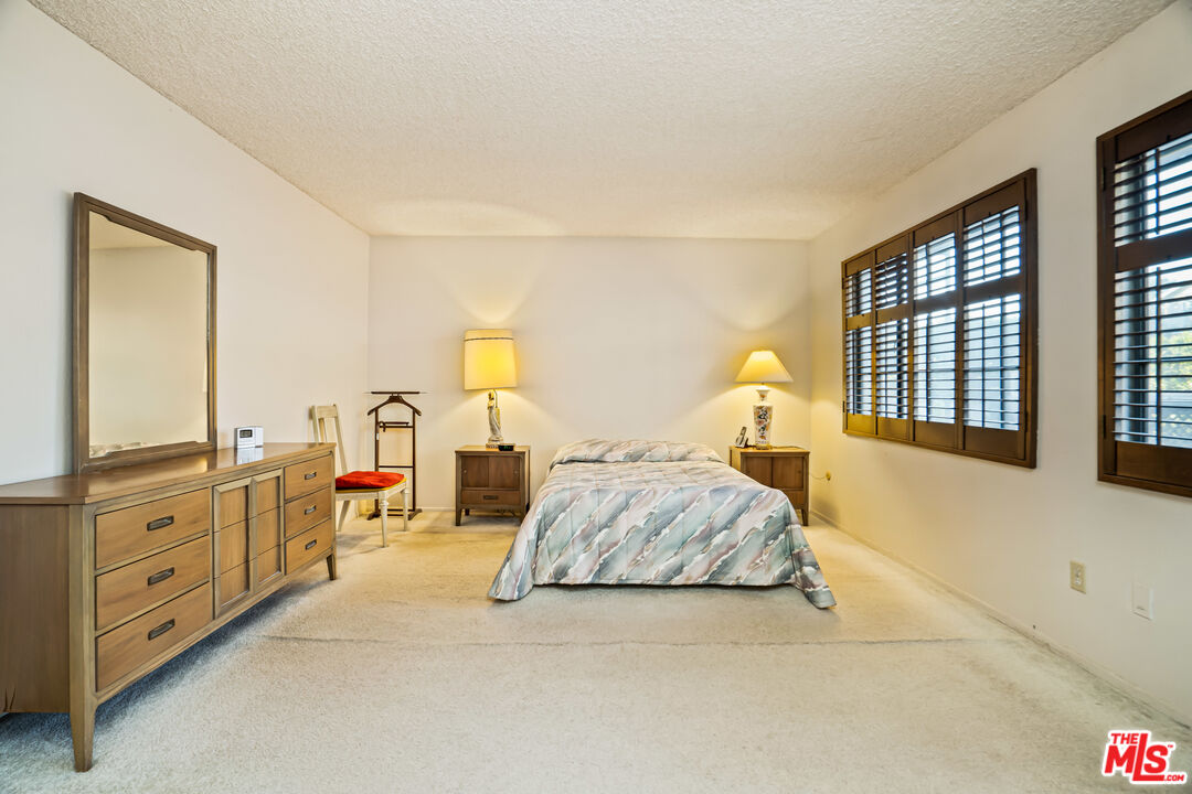 1445 Valley View Road, Unit 2 Glendale, CA 91202 - Photo 28 of 36 a bedroom with a bed and dresser with mirror