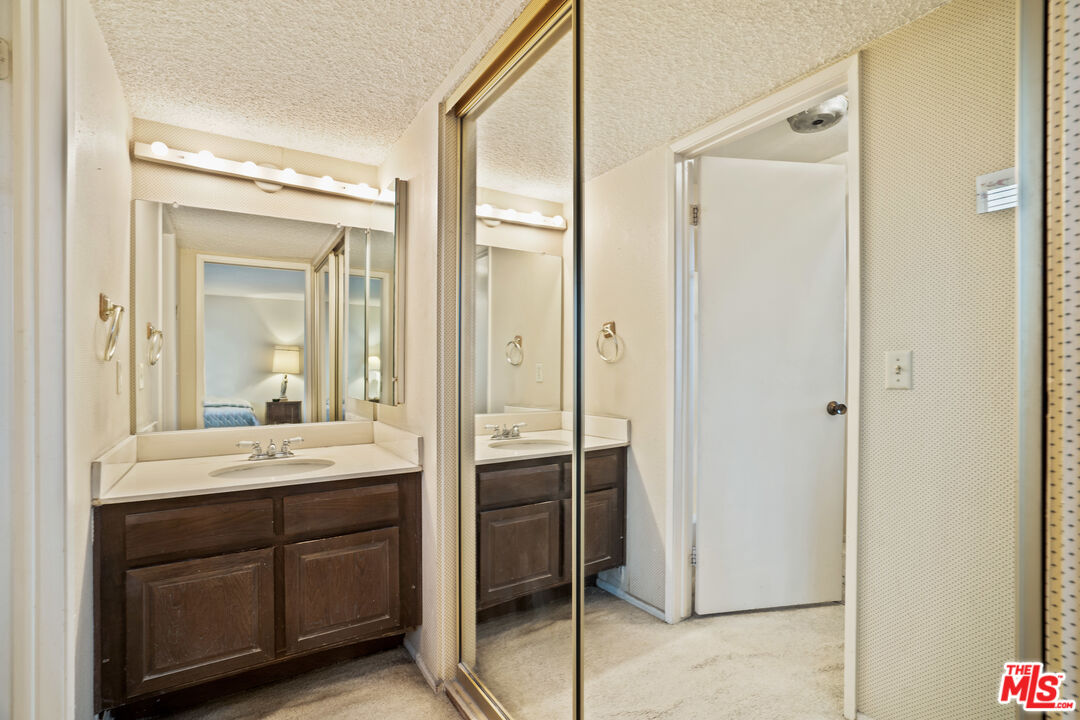 1445 Valley View Road, Unit 2 Glendale, CA 91202 - Photo 30 of 36 a bathroom with a double vanity sink a mirror and a shower