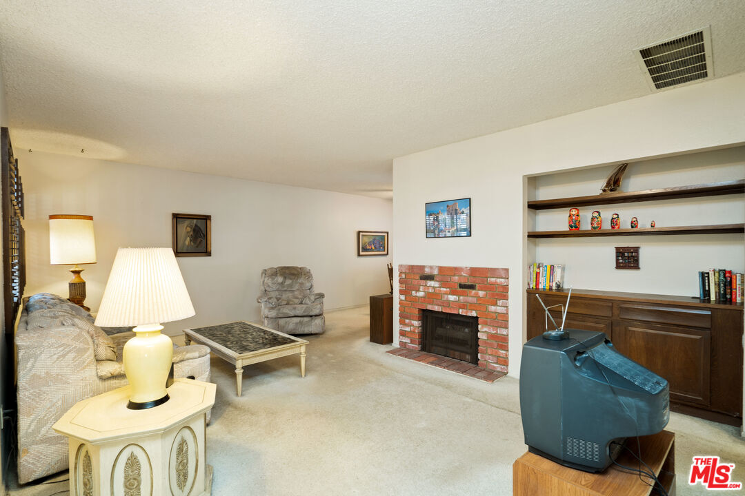 1445 Valley View Road, Unit 2 Glendale, CA 91202 - Photo 6 of 36 a living room with furniture and a fireplace