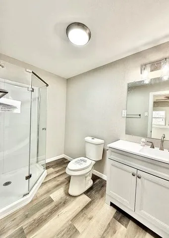 a bathroom with a sink toilet a mirror and shower