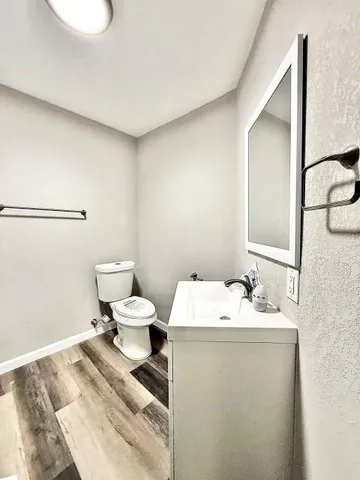 a bathroom with a sink toilet and a mirror