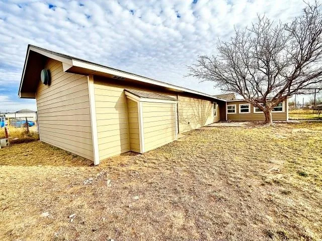 a view of a backyard of the house