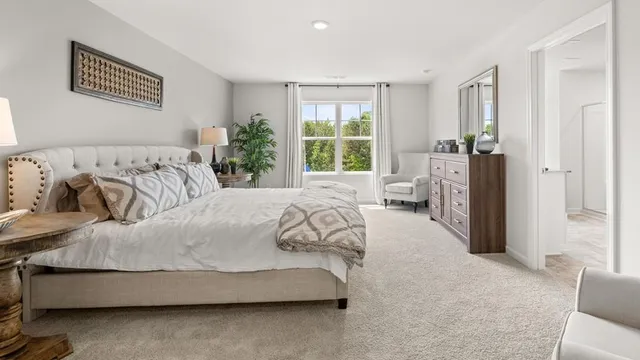 a spacious bedroom with a bed and a couch