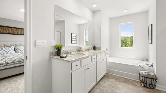 a spacious bathroom with a granite countertop sink a toilet and a bathtub
