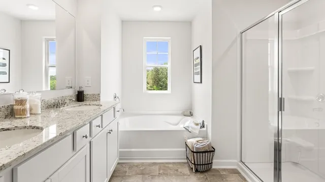 a bathroom with a tub sink and a mirror