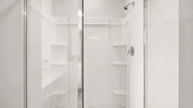 a bathroom with a glass shower door