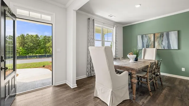 a view of a dining room with furniture window and wooden floor