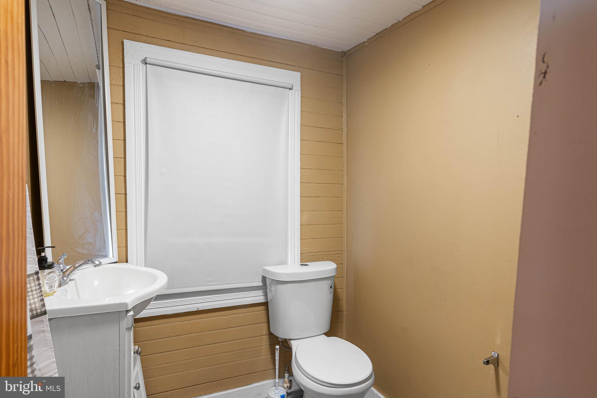412 East State Street Delmar, MD 21875 - Photo 17 of 36 a bathroom with a granite countertop toilet and a sink