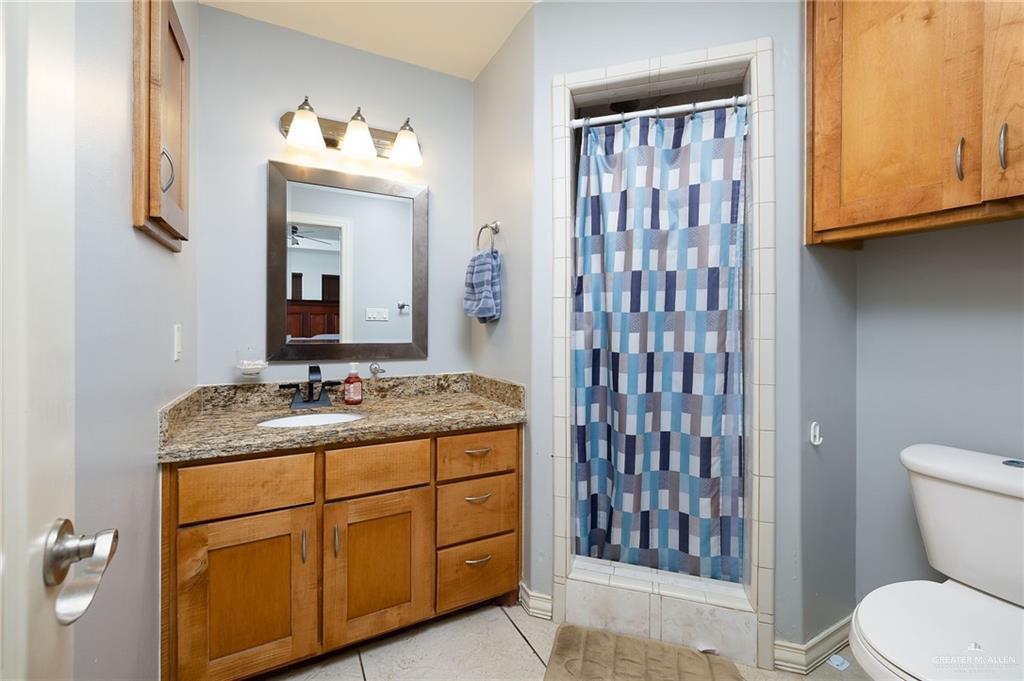 3609 Paseo Del Rey Edinburg, TX 78542 - Photo 11 of 20 a bathroom with a granite countertop sink toilet and mirror