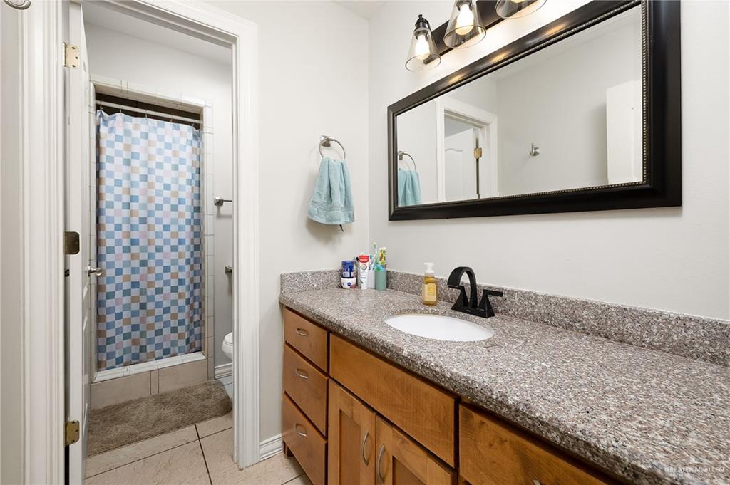 3609 Paseo Del Rey Edinburg, TX 78542 - Photo 13 of 20 a bathroom with a granite countertop sink and a mirror