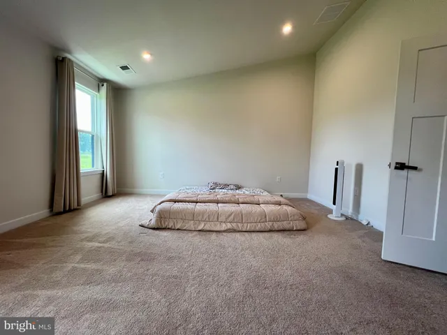 a room with a bed and a window