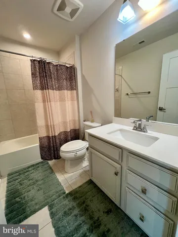a bathroom with a double vanity sink toilet and shower