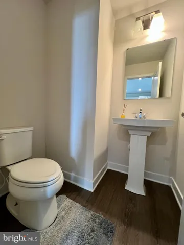 a bathroom with a sink toilet and mirror