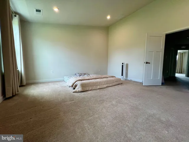 a room with a bed and a night stand