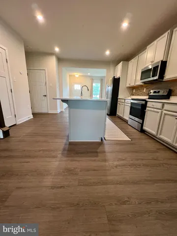 a view of kitchen with microwave and cabinets