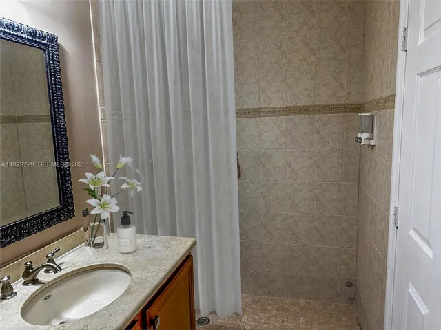 a view of hallway with stairs and a refrigerator