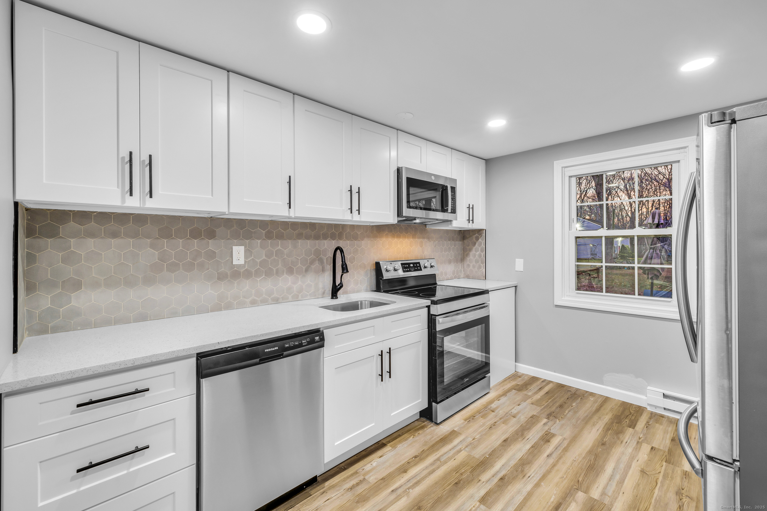 120 Gallup Hill Road, Unit 3C Ledyard, CT 06339 - Photo 2 of 14 a kitchen with stainless steel appliances granite countertop a sink stove and cabinets