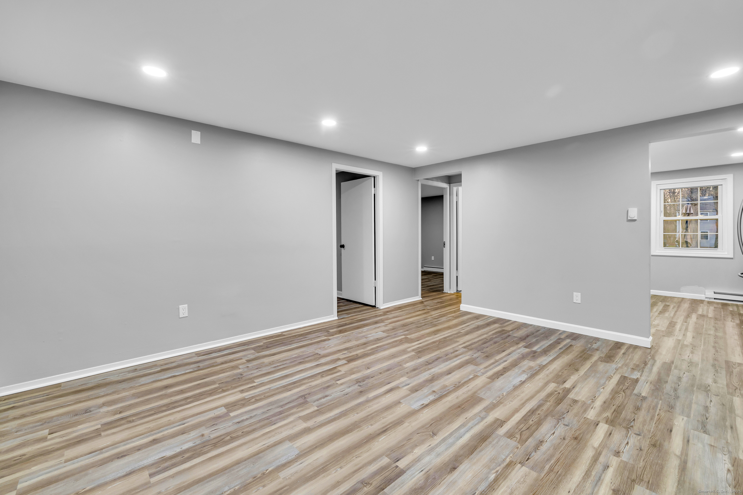 120 Gallup Hill Road, Unit 3C Ledyard, CT 06339 - Photo 6 of 14 a view of an empty room with wooden floor and a window