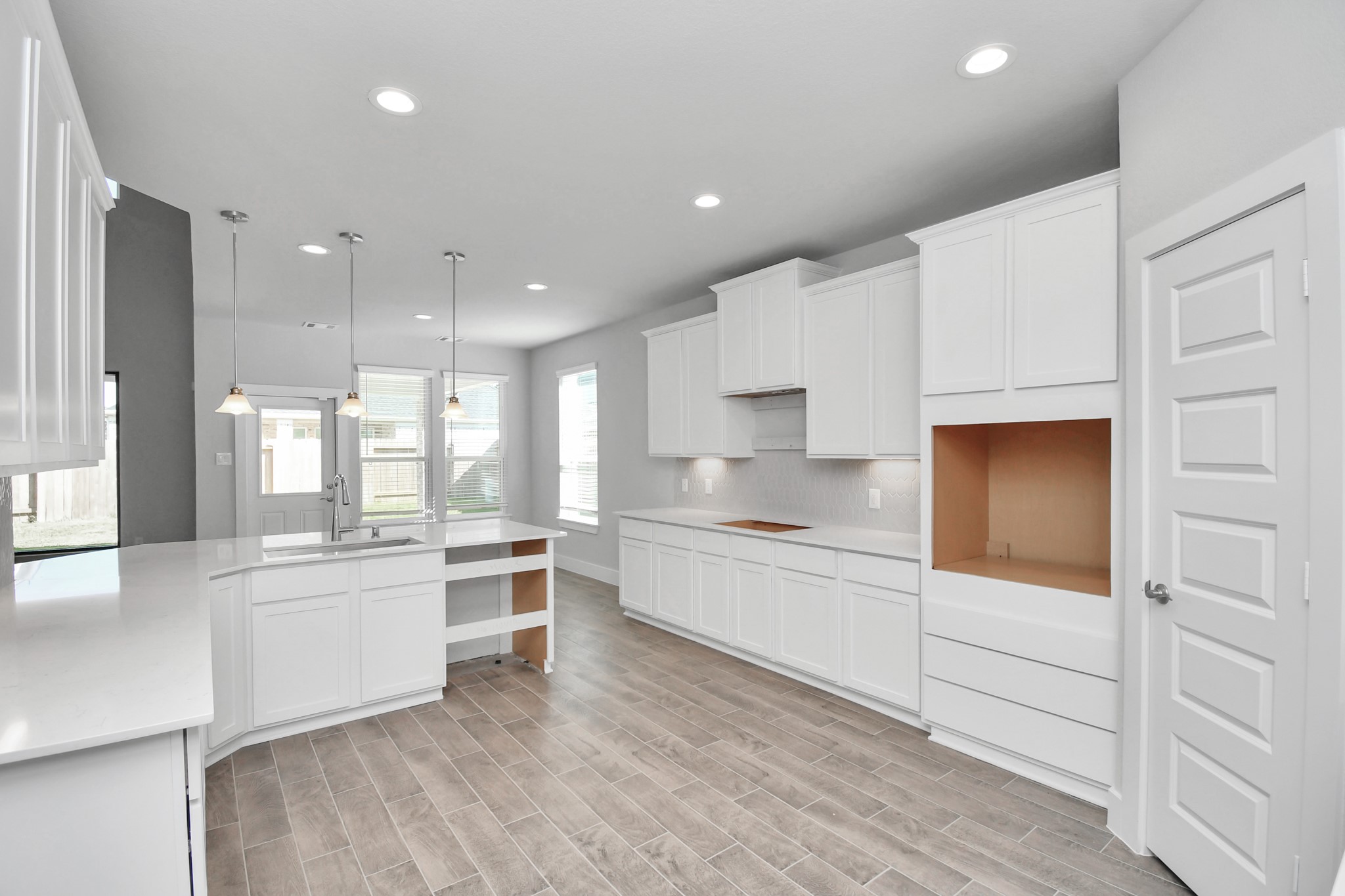 3019 Knotty Frst Drive Spring, TX 77373 - Photo 11 of 47 The extended counter area adds both practicality and style, making meal preparation a breeze. Every detail is thoughtfully designed to enhance the kitchen's functionality and aesthetic appeal.