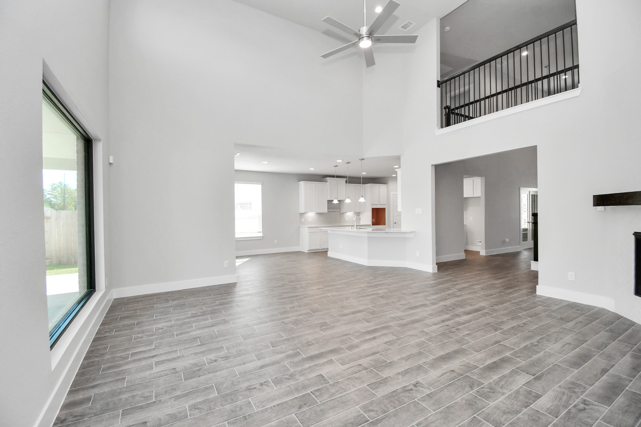 3019 Knotty Frst Drive Spring, TX 77373 - Photo 17 of 47 Welcome family and guests to your charming living room! With its high ceilings, recessed lighting, ceiling fan, custom paint, beautiful flooring, and large windows that let in abundant natural light, this room is perfect for gatherings.