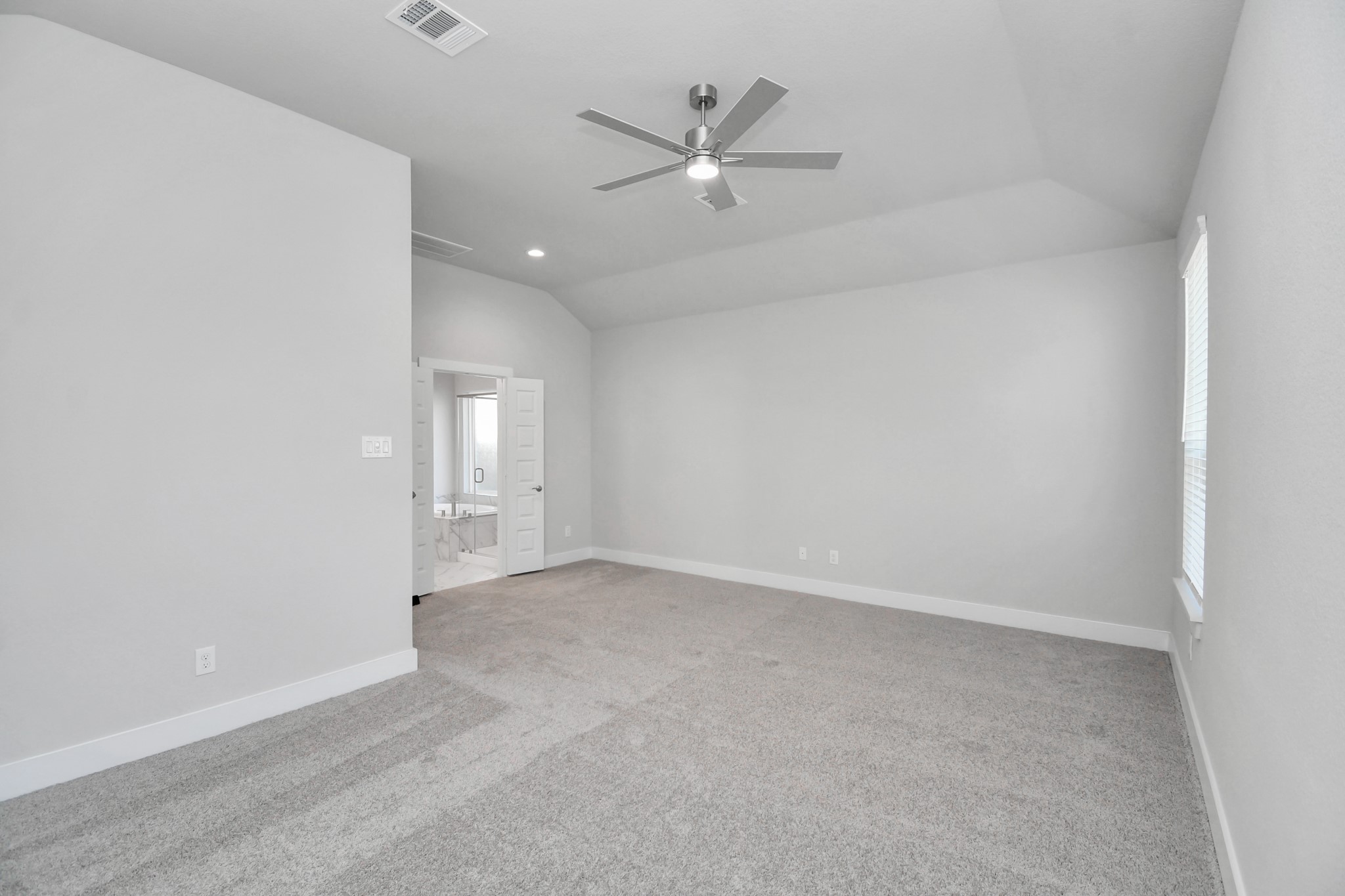 3019 Knotty Frst Drive Spring, TX 77373 - Photo 23 of 47 Escape to tranquility in this spacious primary room, adorned with plush carpeting and bathed in the soothing hues of warm paint colors, creating a cozy retreat for relaxation.