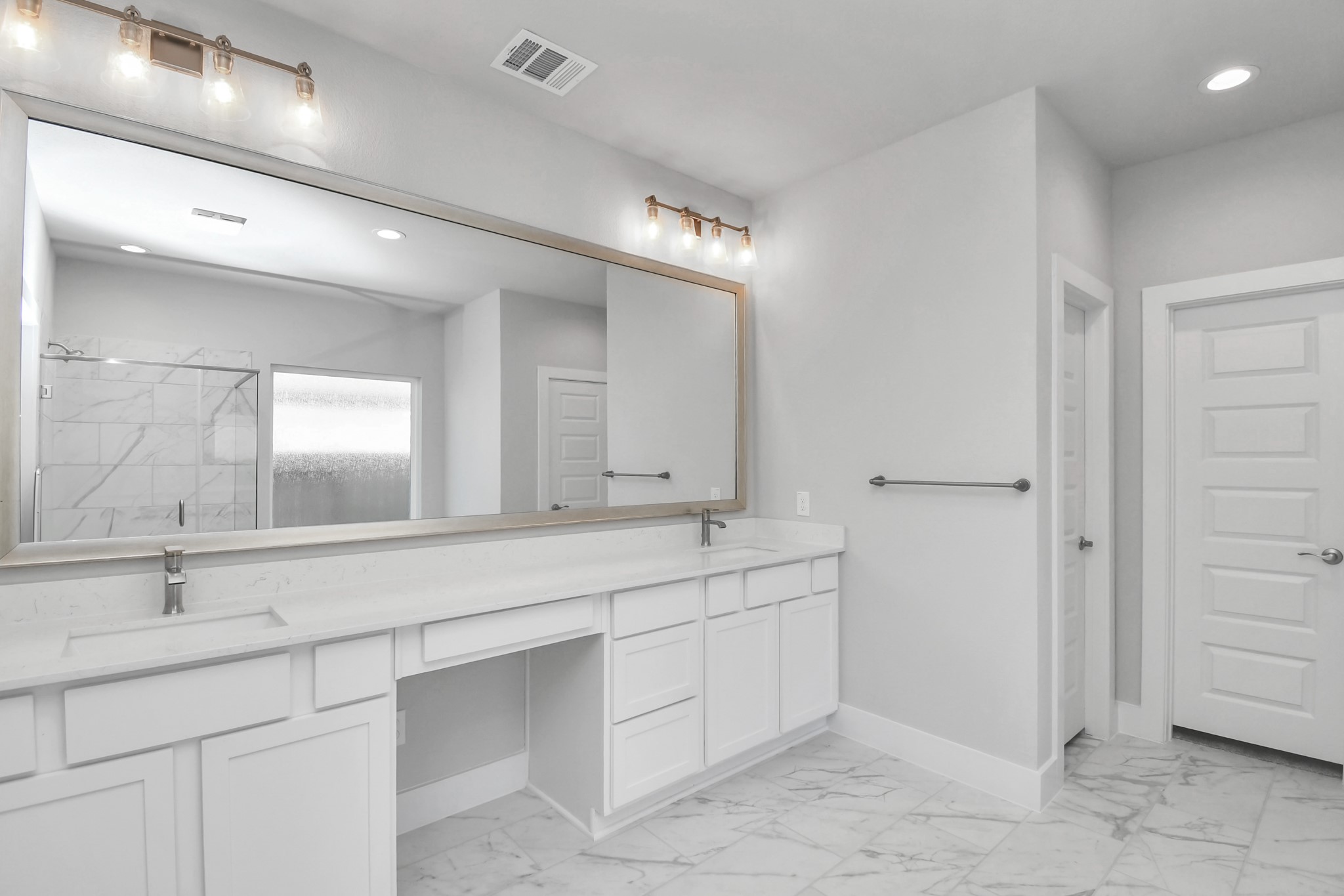3019 Knotty Frst Drive Spring, TX 77373 - Photo 24 of 47 Escape to a spa-like oasis in this primary bathroom. Enjoy a walk-in shower with tile surround, a separate garden tub with custom detailing, and an elegant vanity featuring light countertops, modern hardware, and beautiful vanity lights. Experience luxury and relaxation in every detail.