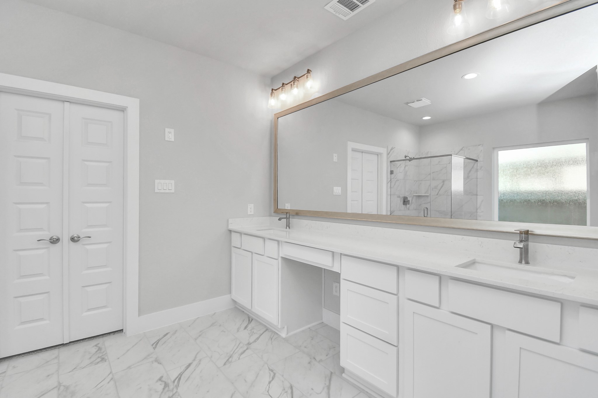 3019 Knotty Frst Drive Spring, TX 77373 - Photo 25 of 47 Elevate your daily routine at the elegant vanity, now equipped with double sinks, light countertops, modern hardware, and beautiful vanity lights.