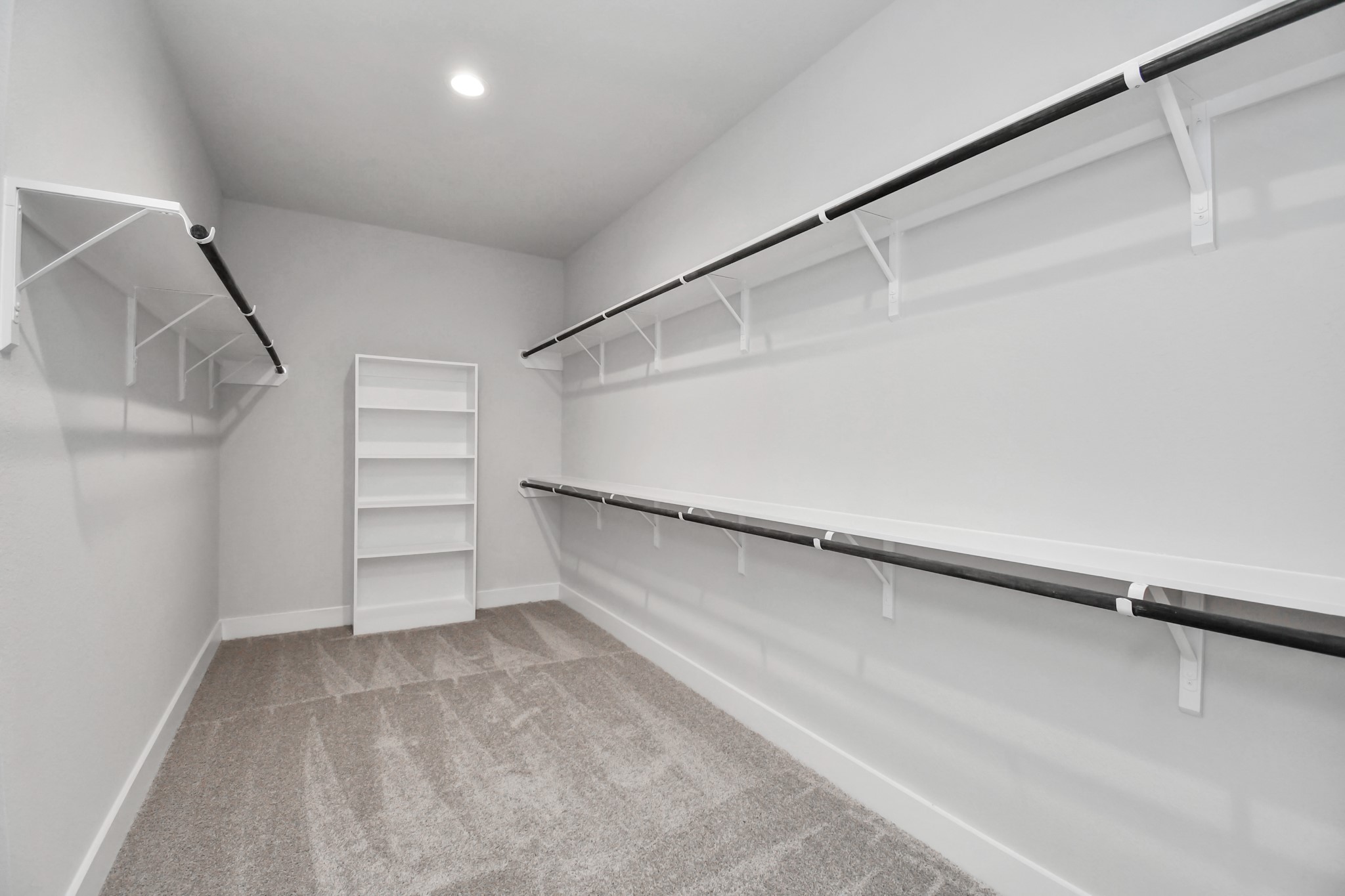 3019 Knotty Frst Drive Spring, TX 77373 - Photo 27 of 47 Walk-in closet that epitomizes luxury and practicality. This generously sized space features built-in shelving, offering abundant room for impeccable organization. High ceilings and recessed lighting create a bright and welcoming ambiance.