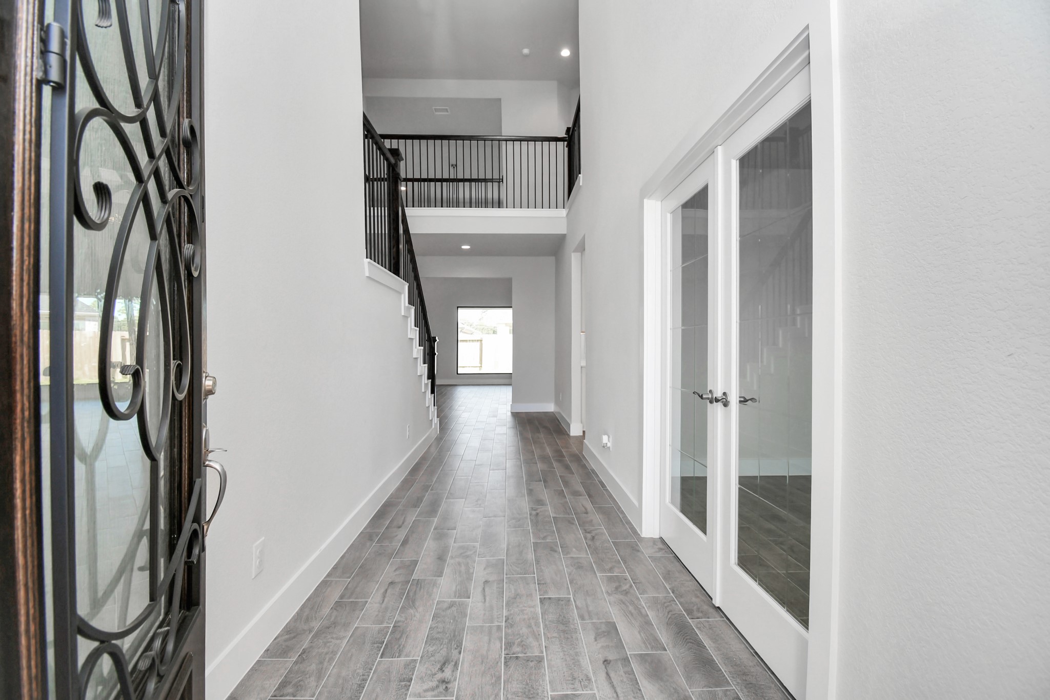3019 Knotty Frst Drive Spring, TX 77373 - Photo 6 of 47 As you step into the threshold of this luxurious home, you'll soon be welcomed by an elegant glass door. Inside, soaring ceilings amplify the spaciousness, while the refined wood-look tile flooring and oversized baseboards exude sophistication and charm.