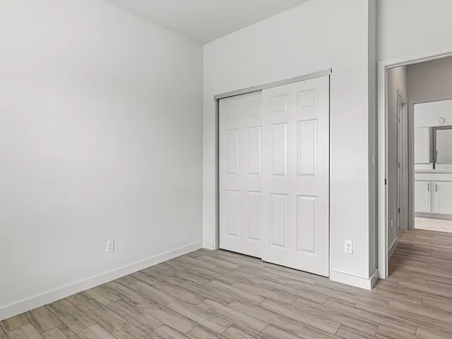 a view of an empty room with wooden floor