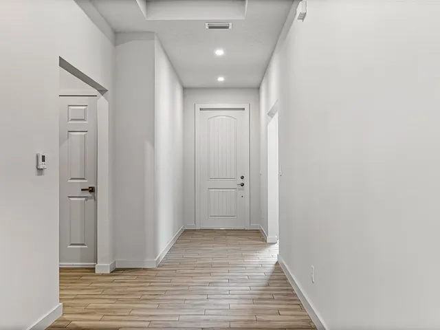 a view of hallway with wooden floor