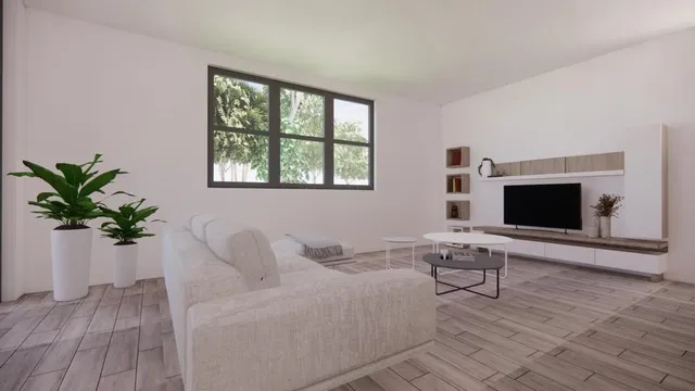 a living room with furniture a flat screen tv and a potted plant