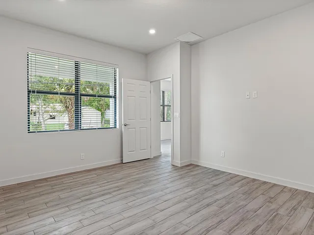wooden floor in an empty room with a window