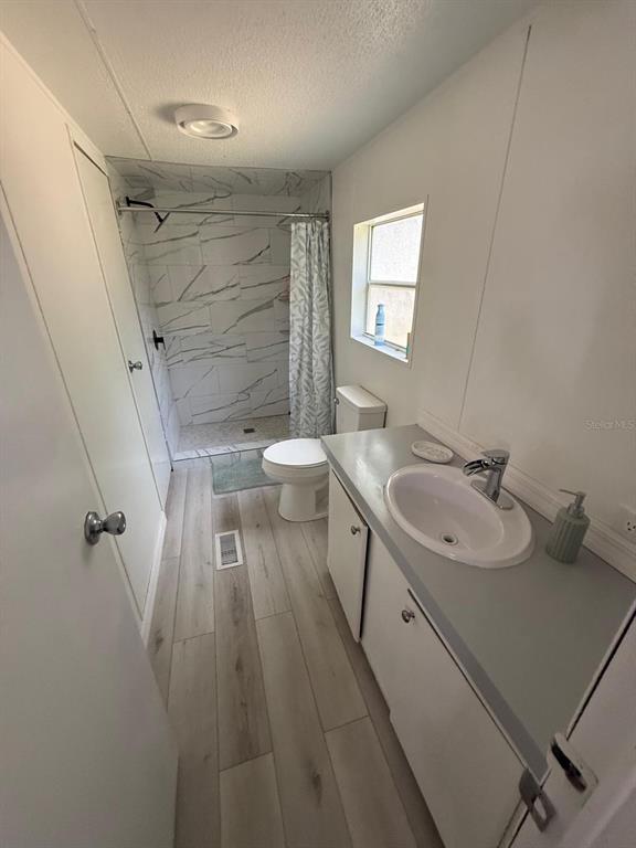 2433 East North Street Inverness, FL 34453 - Photo 7 of 11 a bathroom with a sink a toilet and shower