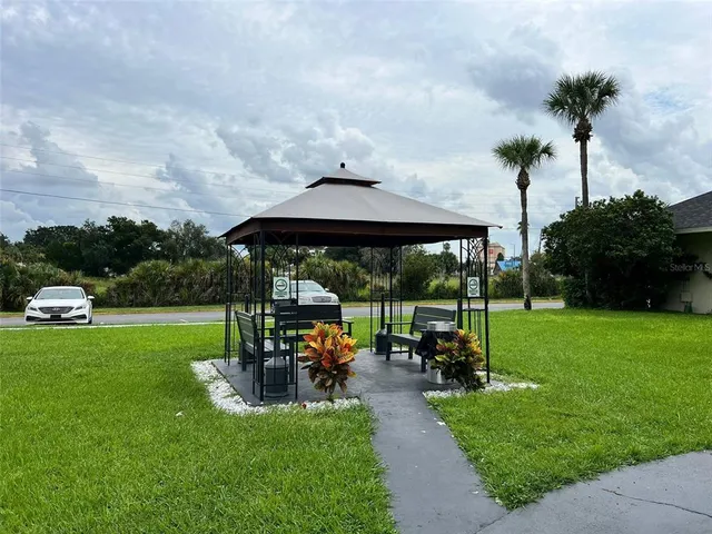 a patio with a table and chairs under an umbrella