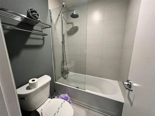 a white toilet sitting next to a bath tub