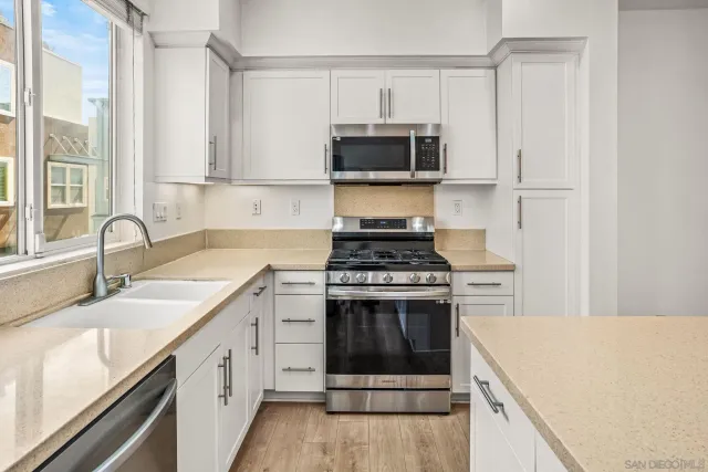 a kitchen with a sink stove and microwave