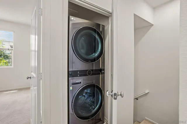 a view of a hallway with washer and dryer