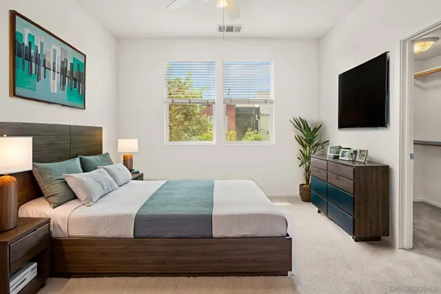 a bedroom with a large bed and a flat screen tv
