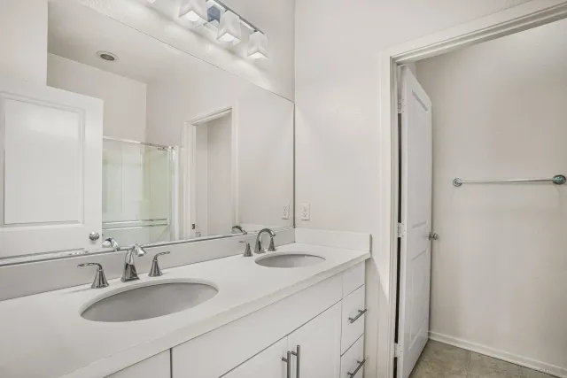 a bathroom with 2 sink and a mirror