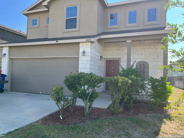 a view of a house with a yard and plants