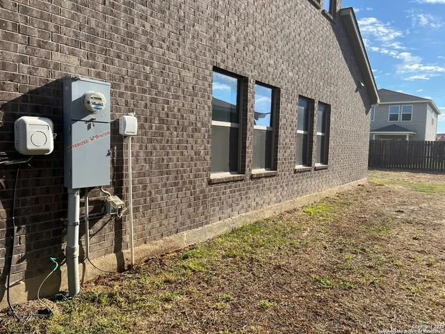 a front view of house with wooden fence