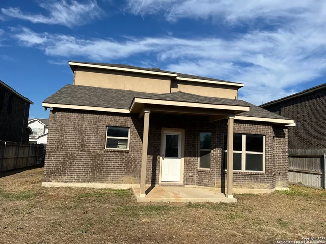 a view of a door of the house and a yard