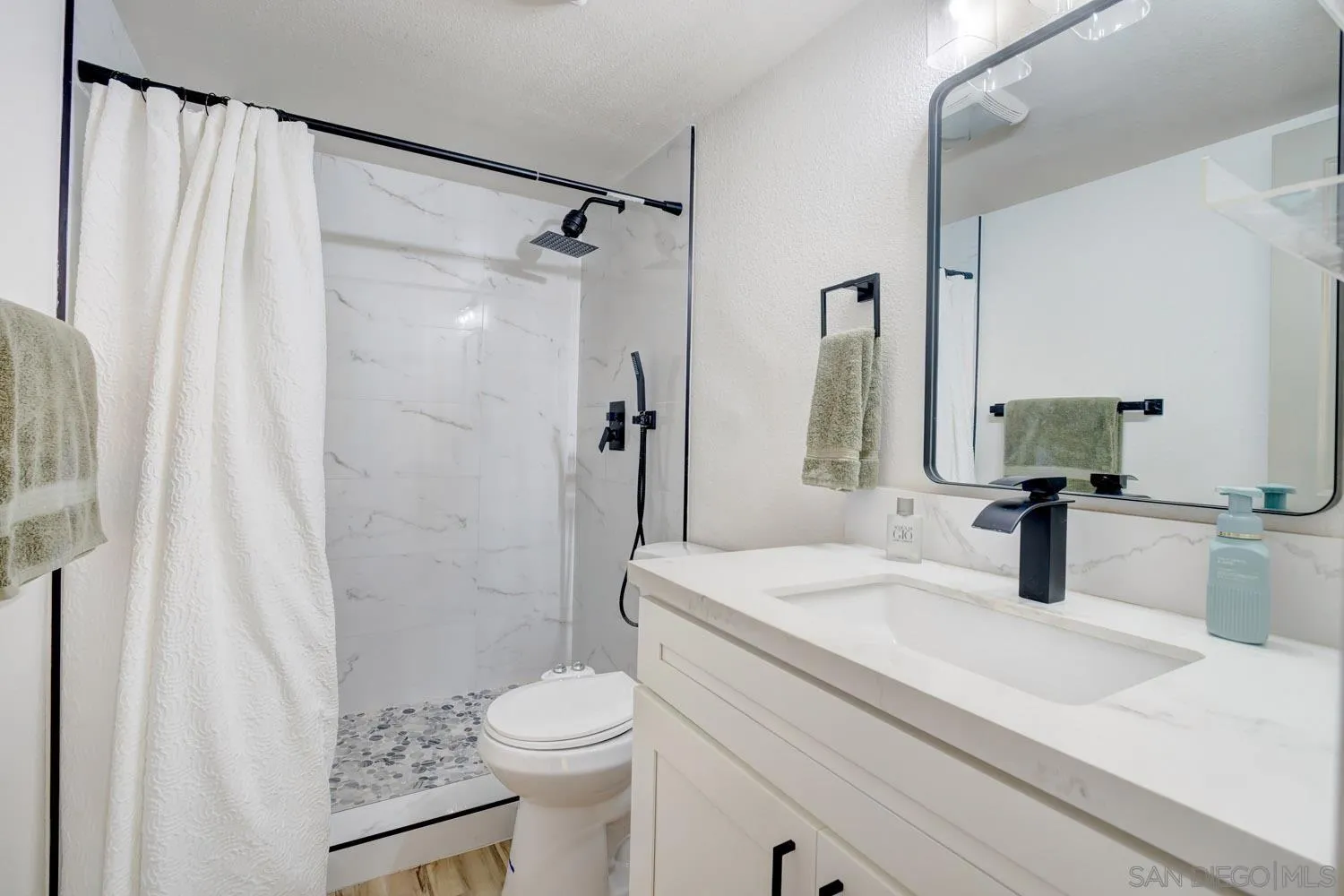 10784 Tamar Terrace, Unit C Santee, CA 92071 - Photo 11 of 33 a bathroom with a sink a toilet a mirror and shower